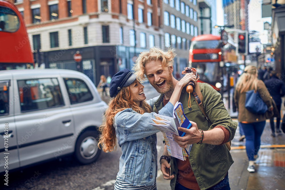 Joyful couple exploring the city with a map Joyful couple exploring the city with a map