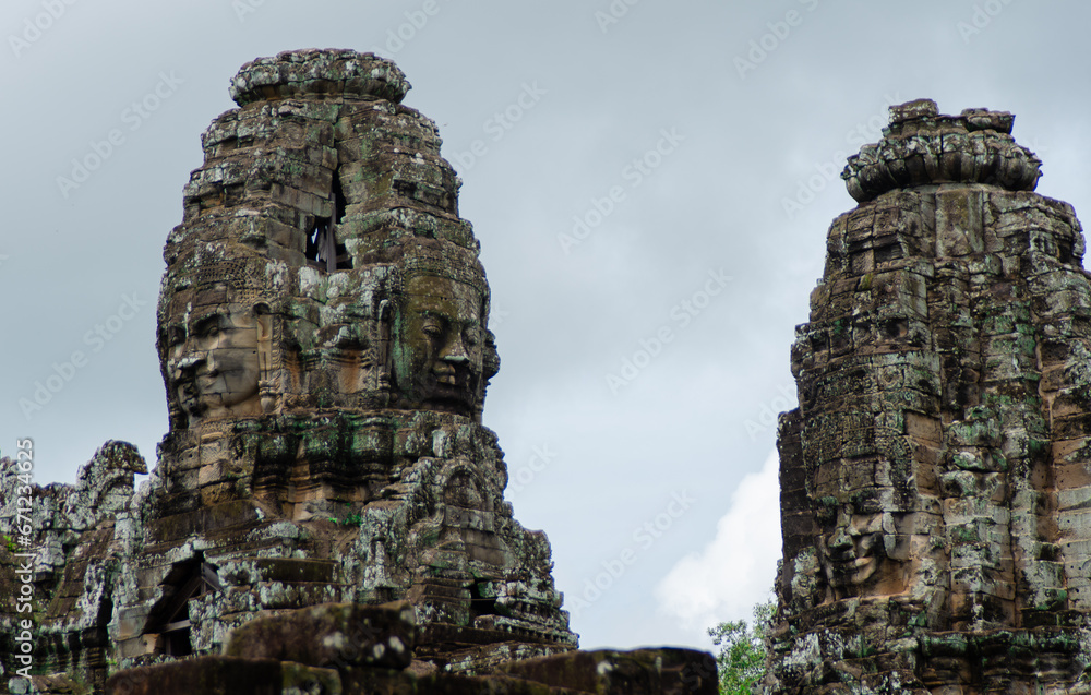 Ancient Buddhist Temple Ruins of Angkor Wat in Siem Reap, Cambodia. Stone Carved Faces In Old Pillars.