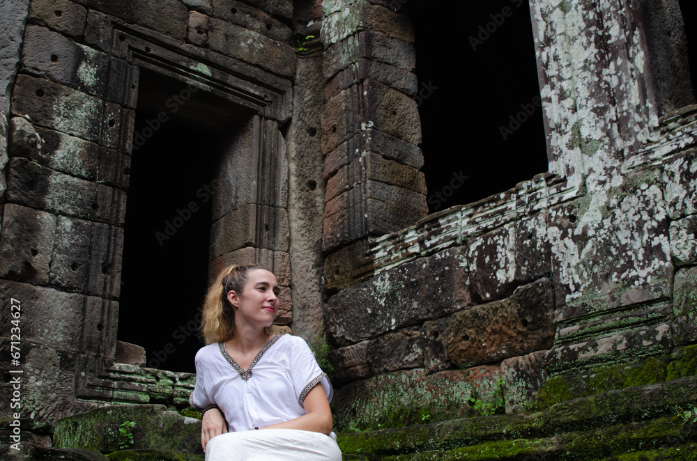 Caucasian Tourist Woman Enjoying and Relaxing The Temples Of Angkor Wat In Cambodia Caucasian Tourist Woman Enjoying and Relaxing The Temples Of Angkor Wat In Cambodia