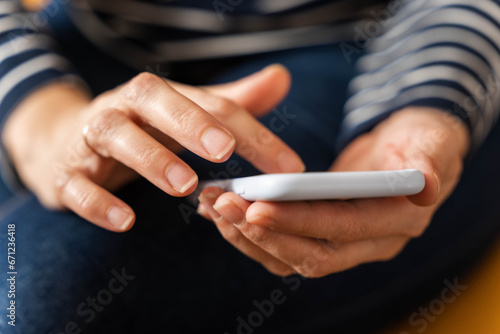 women s hands that confidently hold a smartphone  modern technology