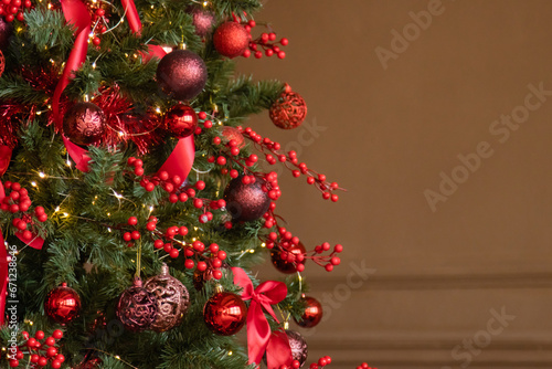 Christmas interior in red and brown tones. Beautiful furniture in the living room, Christmas tree with toys