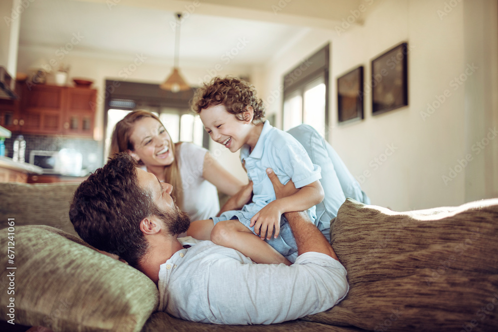 Joyful family sharing a playful moment in their living room Joyful family sharing a playful moment in their living room