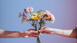Hands of women holding bouquet of colorful flowers on blue background