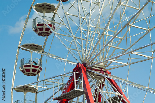 Ferris wheel in an amusement park against a blue sky