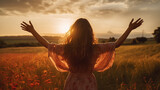  Happy woman standing with her back to the camera on sunset in nature with her hands open 