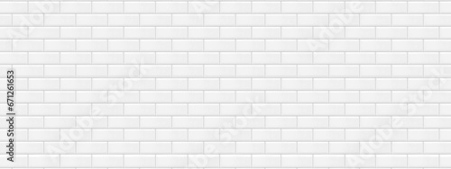 White textured wall of ceramic tiles imitating bricks in the wall. Geometric metro tiles repeating pattern. Pristine surface with no scrapes, cracks or scratches. 