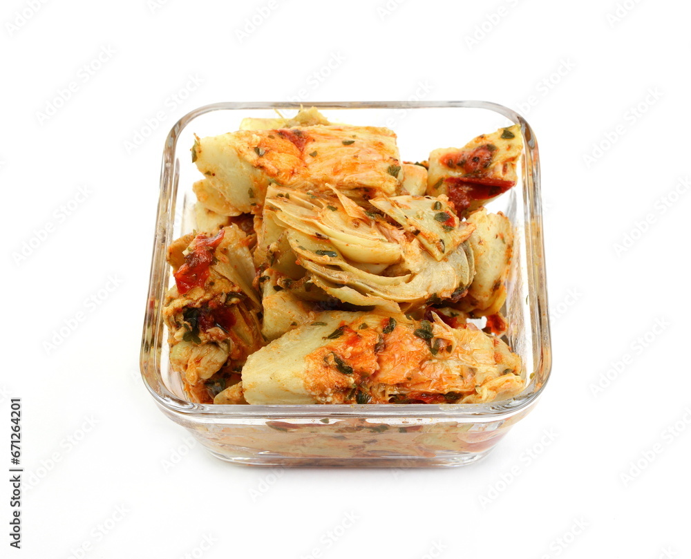 artichokes salad with vegetable mix sauce dressing in a bowl isolated on white background. artichokes salad with vegetable mix sauce dressing in a bowl isolated on white background.