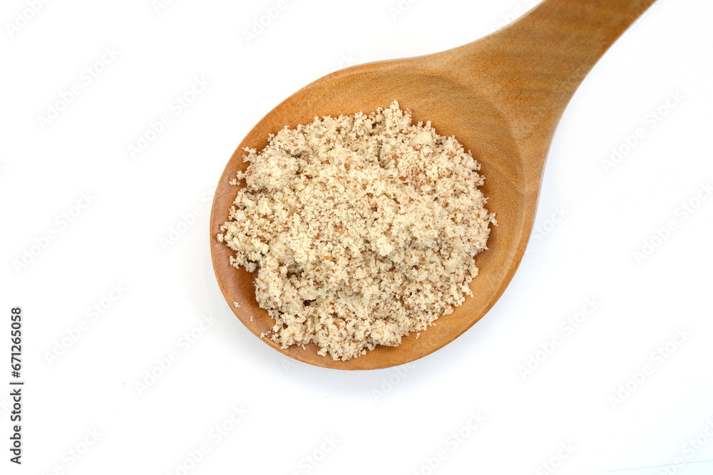 Shelled and ground Ground, milled, crushed almond nuts in a wooden spoon isolated on white. Edible, dried, brown seeds of Prunus dulcis. Ingredient in marzipan, nougat, cookies. Shelled and ground Ground, milled, crushed almond nuts in a wooden spoon isolated on white. Edible, dried, brown seeds of Prunus dulcis. Ingredient in marzipan, nougat, cookies.