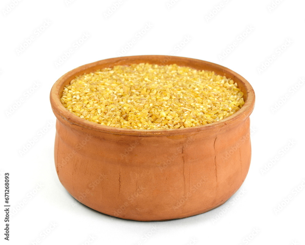 Raw Bulgur in a bowl Isolated on a white background. Raw bulghur, dry cracked parboiled wheat groats, cereal Raw Bulgur in a bowl Isolated on a white background. Raw bulghur, dry cracked parboiled wheat groats, cereal