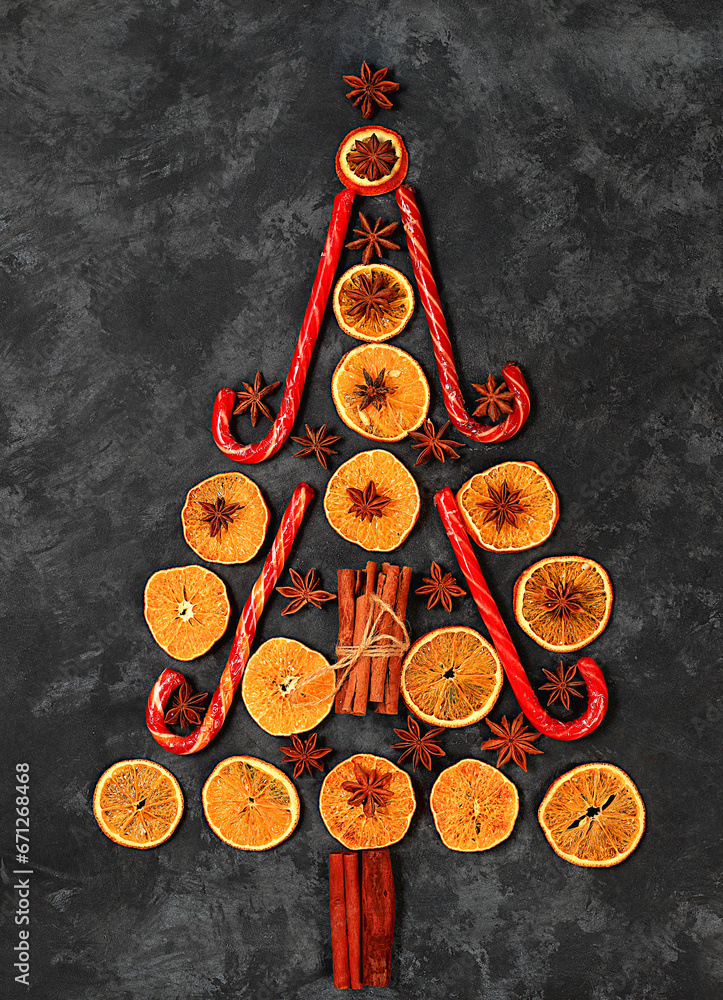 Christmas background in the form of an edible Christmas tree with winter traditional spices to improve immunity during the cold period. Star anise, cinnamon and dried oranges 