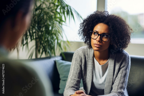 A pensive female patient consults with her therapist, sharing her innermost thoughts and feelings photo