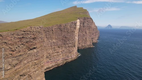 FAROE ISLANDS - JULY.16.2023 - Excellent aerial footage moving towards and over the Traelanipa cliffs bordering Sorvagsvatn Lake in the Faroe Islands. photo