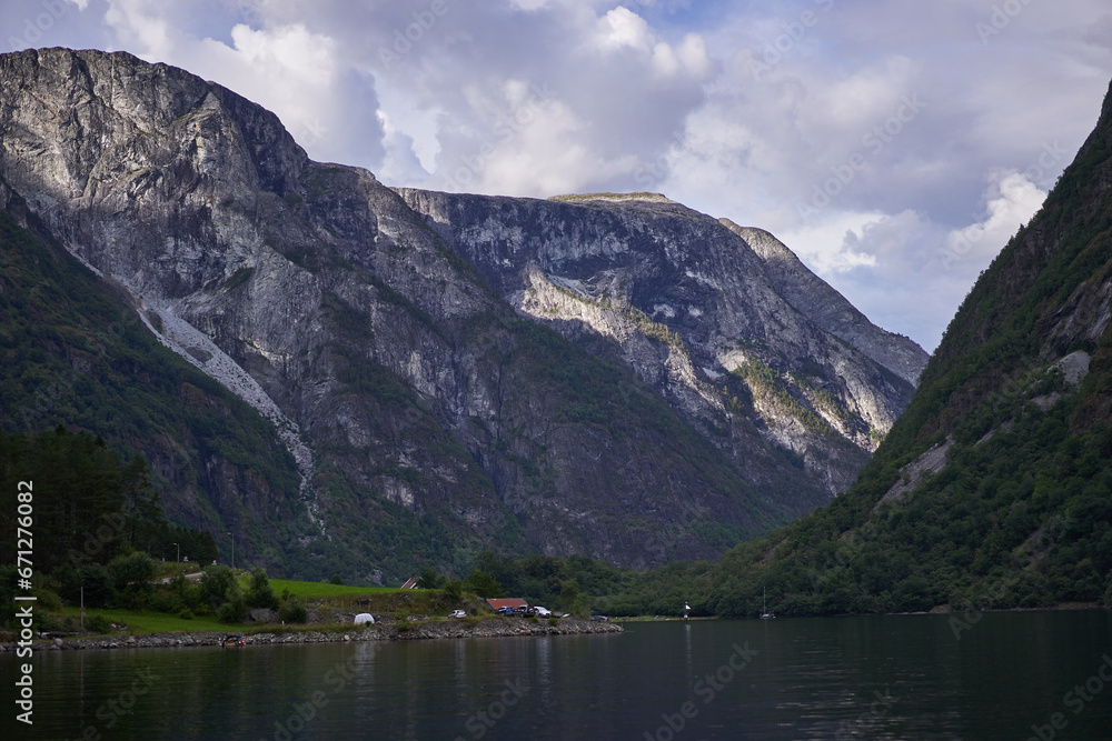 Landscape picture of Aurlandsfjorden fjord in norwegian region Aurland in calm summer evening. Beautiful place with clean nature, high mountains and deep walley, pefect to spend active summer holiday. Landscape picture of Aurlandsfjorden fjord in norwegian region Aurland in calm summer evening. Beautiful place with clean nature, high mountains and deep walley, pefect to spend active summer holiday.