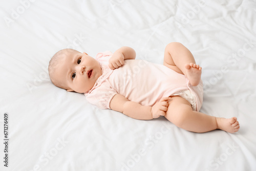 Little cute baby lying on bed at home
