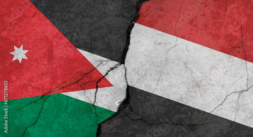 Jordan and Yemen flags, concrete wall texture with cracks, grunge background, military conflict concept