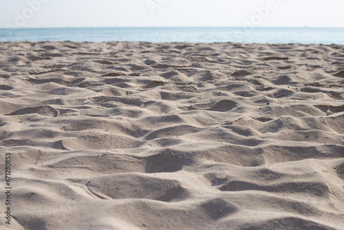 Beach sand texture with sea and sky for background.