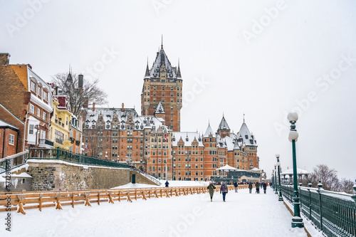 Dufferin Terrace, a long wooden sidewalk next to the historic Fairmont Chateau Frontenac hotel, giant tobogganing run in the winter on a snowy day, Quebec City, Canada. Photo taken in December 2022.
