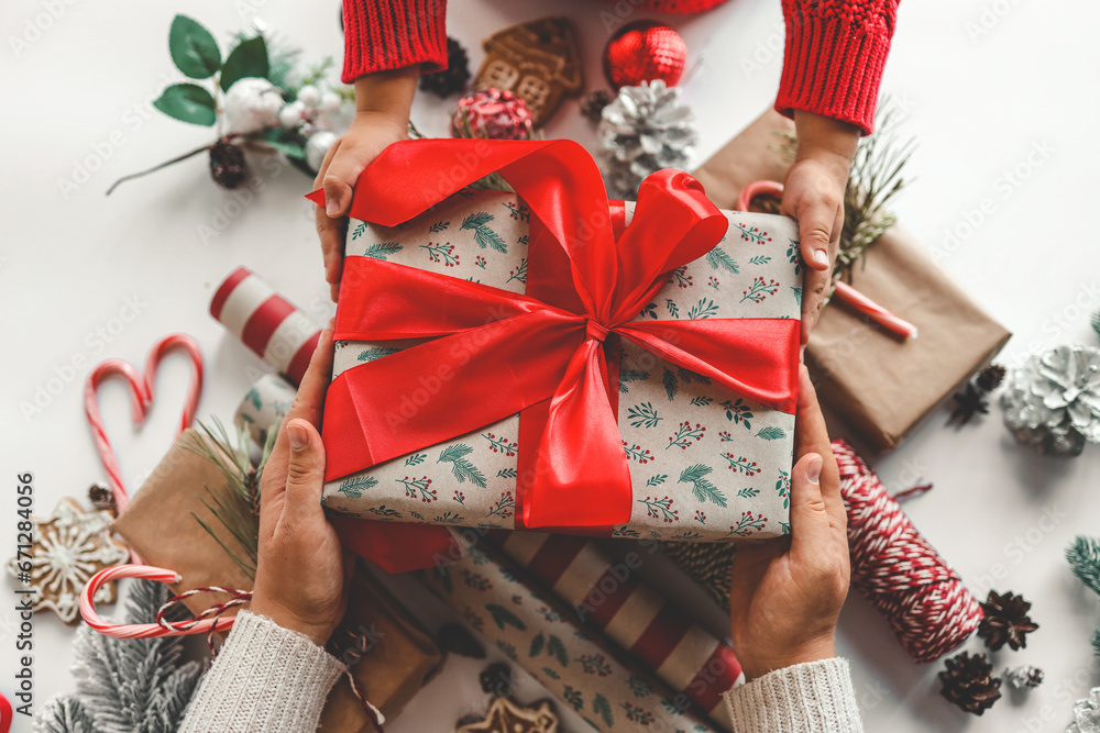 Mom and child holding a Christmas gift