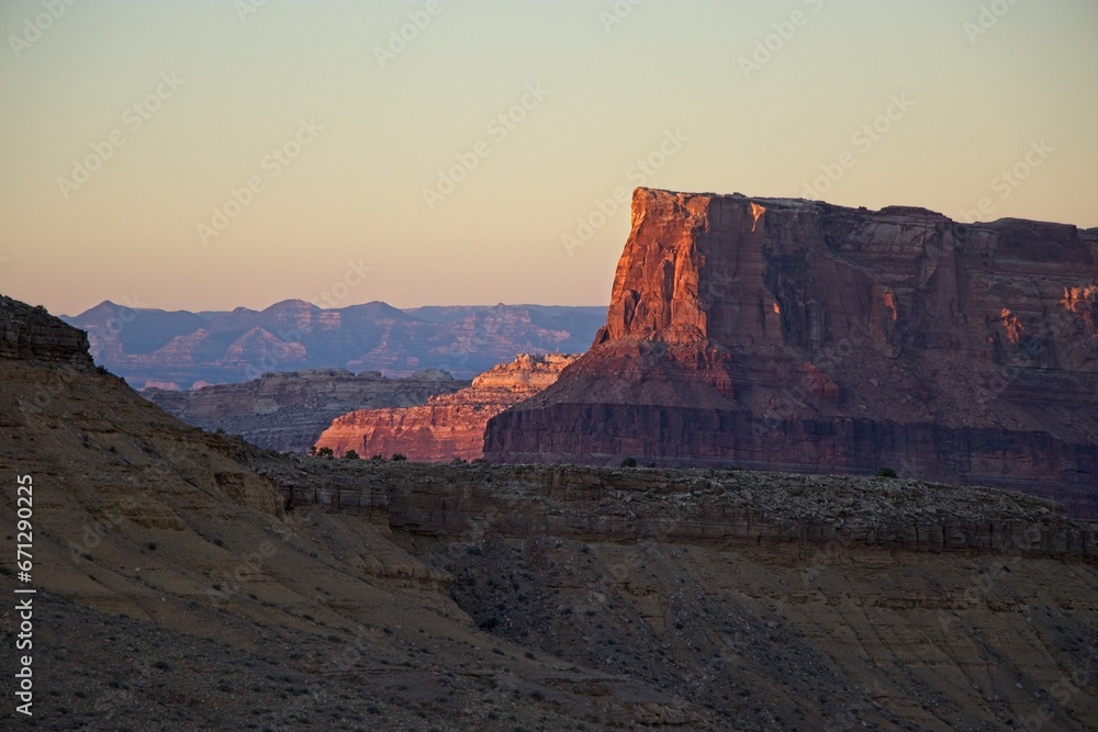Fototapeta premium Interstate 70 winds through the San Rafael Swell, a high desert region of unique landforms like mesas and buttes and pastures on top