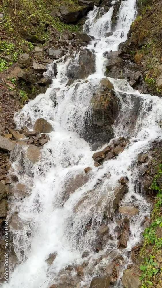 Waterfall in the forest. Mountain stream. Waterfall in nature. A view of the waterfall, where fast-flowing water cascades rapidly down the rocks. Trufanets waterfall, a waterfall in the Carpathians. Waterfall in the forest. Mountain stream. Waterfall in nature. A view of the waterfall, where fast-flowing water cascades rapidly down the rocks. Trufanets waterfall, a waterfall in the Carpathians.