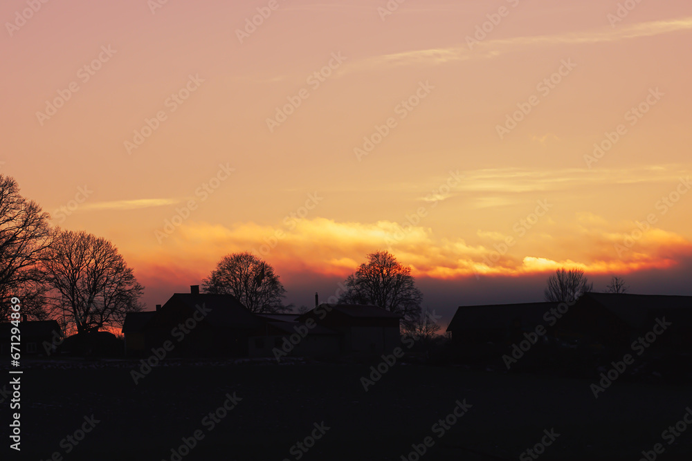 Silhouette trees and buildings against sky during sunset Silhouette trees and buildings against sky during sunset