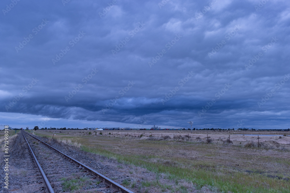 Stormy clouds along rail tracks