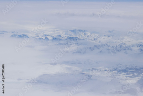 Beautiful high snow Greenland mountain peak landscape in clouds © ungvar