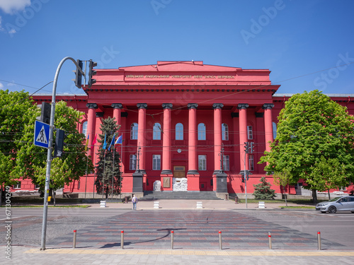 red exterior of National Taras Shevchenko University of Kyiv and cross road in capital kyiv