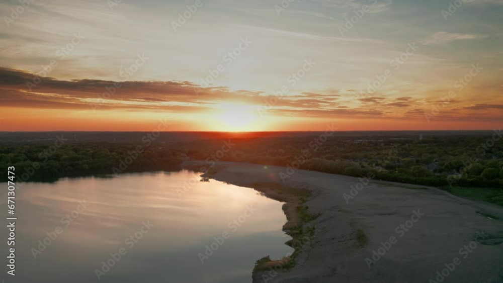 The flight above the lake in park on a sunset background. Wide shot The flight above the lake in park on a sunset background. Wide shot