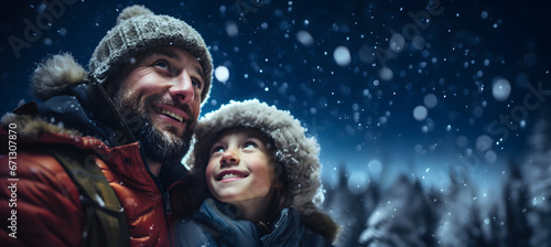 father with his daughter on snowy Christmas night waiting for the arrival of Santa Claus - copy space