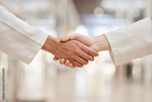 Doctors, partnership and handshake for collaboration, agreement and teamwork. Shaking hands, medical professional and people in cooperation for healthcare, wellness and thank you, welcome and success