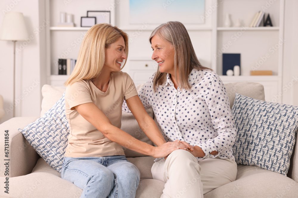 Happy mature mother and her daughter spending time together at home Happy mature mother and her daughter spending time together at home