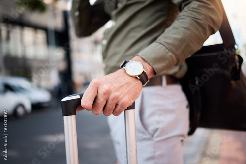 Suitcase, man hand and city with business person, watch and professional on urban street. Luggage, work travel and commute on a road with carry on bag for career and businessman holiday in town