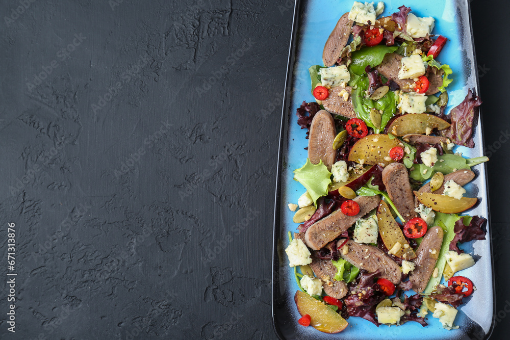Delicious salad with beef tongue and cheese on black textured table, top view. Space for text