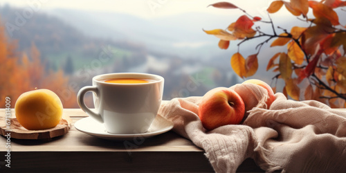 Cup of hot coffee ,apples, knitted scarf, on the window age with autumn scene outside,