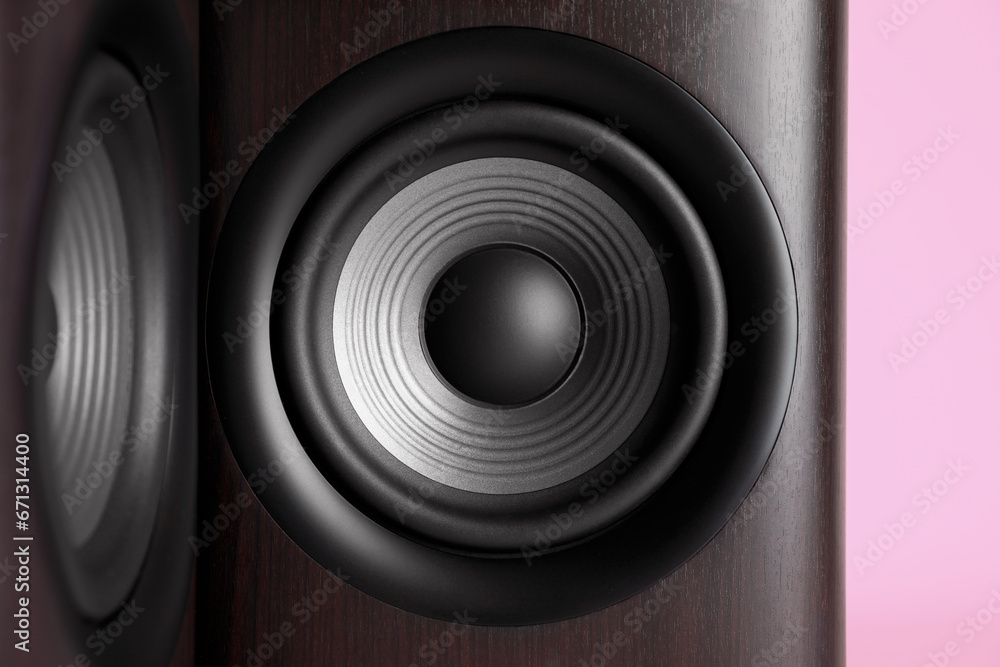 Wooden sound speakers on pink background, closeup Wooden sound speakers on pink background, closeup