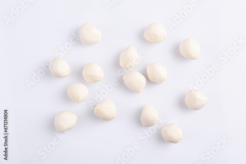 Tasty mozzarella balls on white background, flat lay