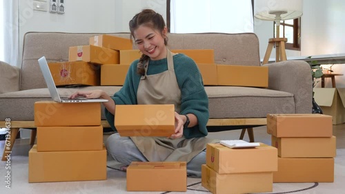 Cheerful woman entrepreneur working with laptop computer and success to selling product online at home office, SME business