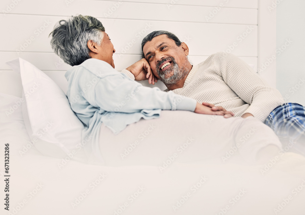 Fototapeta premium Love, relax and a senior couple in bed together, bonding in the morning while enjoying retirement in their home. Happy, conversation and an old man with his wife in the bedroom while on holiday