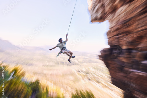 Sports, rock climbing and jump with man on mountain for fitness, adventure and challenge. Rope, workout and hiking with person training on cliff in nature for travel, freedom and exercise mockup