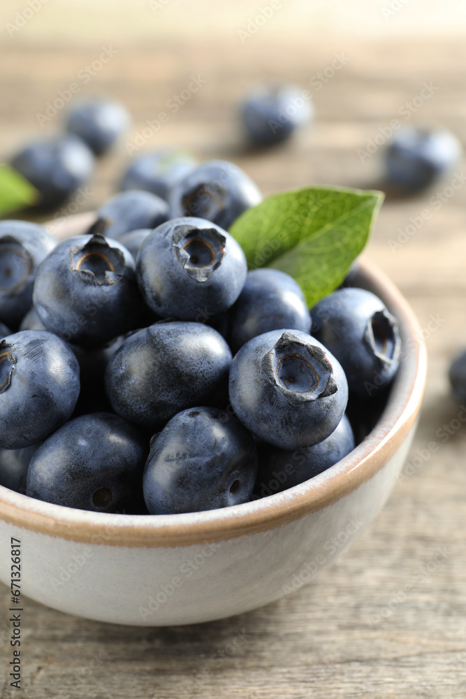 Bowl of tasty fresh blueberries on wooden table, closeup Bowl of tasty fresh blueberries on wooden table, closeup