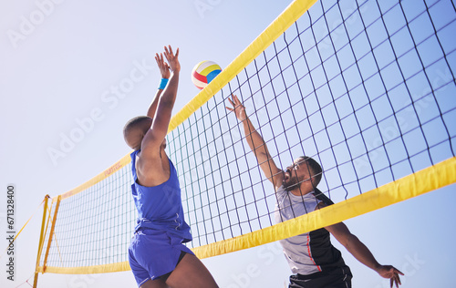 Jump, hit and beach, volleyball and men at net with sports action, fun and summer competition with blue sky. Energy, ocean games and volley challenge with athlete hitting ball for goal in nature. photo