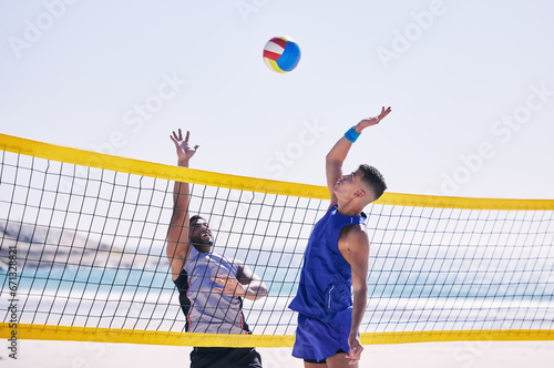 Beach, volleyball and men at net with sports action, fun and summer competition with motivation to win. Energy, ocean games and volley challenge with team hitting ball for goal at workout in nature. photo
