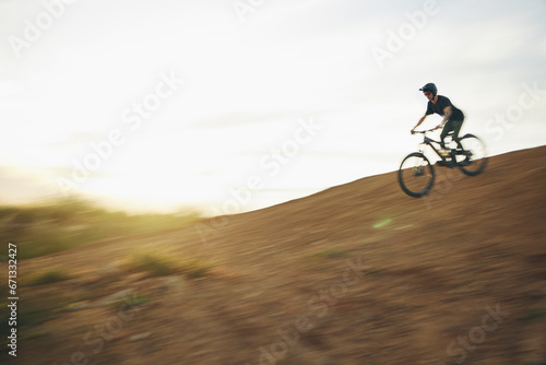 Mountain bike, downhill and man outdoor in nature for sports training and fast speed. Adrenaline, blur and male athlete person with bicycle for off road cycling, travel or adventure on a hill