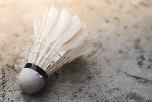 Shuttlecock on cement floor  badminton sport concept.