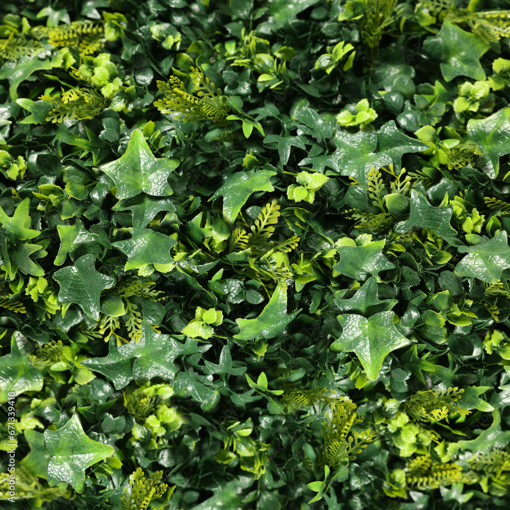 Obraz premium Lush bright green artificial plants as background