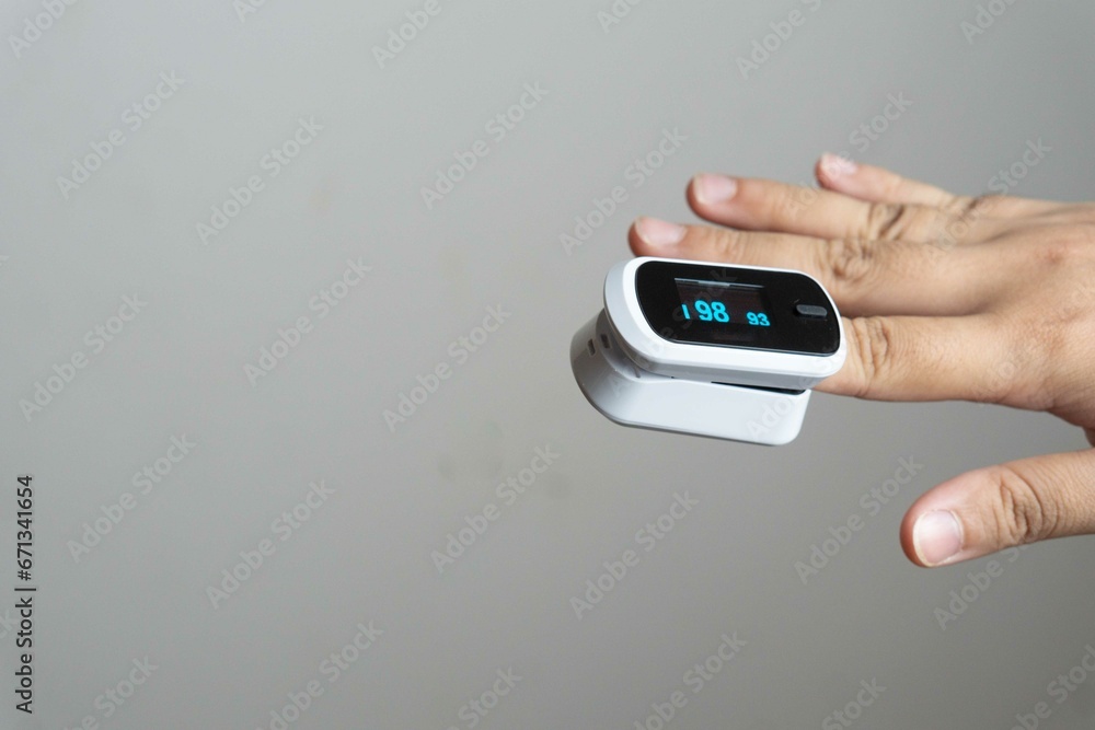 Close up of human finger while using Pulse Oximetry isolated on white background. Close up of human finger while using Pulse Oximetry isolated on white background.