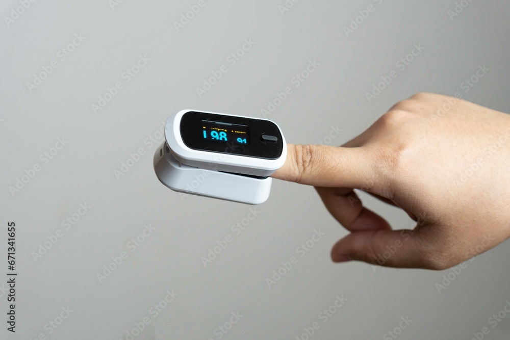 Close up of human finger while using Pulse Oximetry isolated on white background. Close up of human finger while using Pulse Oximetry isolated on white background.