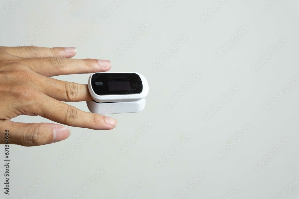 Close up of human finger while using Pulse Oximetry isolated on white background. Close up of human finger while using Pulse Oximetry isolated on white background.