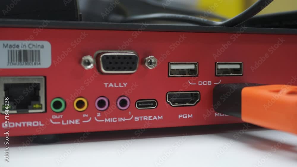 Technician hand plug in cable wire to video capture board close up view inside studio. Electricity tool concept Technician hand plug in cable wire to video capture board close up view inside studio. Electricity tool concept
